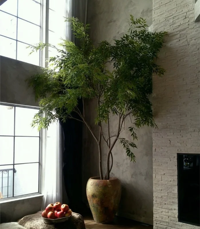 A decorative artificial tree in a modern living room.