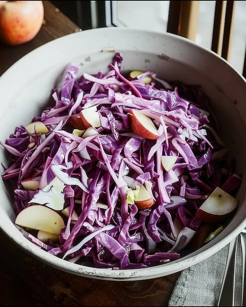 Red cabbage apple slaw fresh ingredients in a bowl